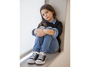 In this Nov. 28, 2017 photo, actress Brooklynn Prince poses for a portrait in New York to promote her film, "The Florida Project." Her performance as Moonee, a brash, troublemaking pipsqueak living with her mom (Bria Vinaite) in a low-rent Orlando motel, may be the most spirited thing of 2017.