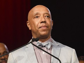 FILE - In this July 18, 2015 file photo, Russell Simmons speaks appears at the RUSH Philanthropic Arts Foundation's Art for Life Benefit in Water Mill, N.Y. Three women have told the New York Times that music mogul Russell Simmons raped them. Simmons, in a statement to the paper, vehemently denied what he called "these horrific accusations," saying all his relations have been consensual.
