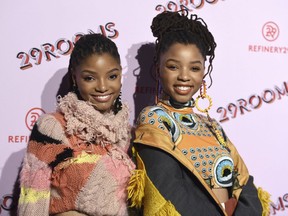 FILE - In this Dec. 6, 2017 file photo, Halle Bailey, left, and Chloe Bailey, of Chloe x Halle, appear at the West Coast debut of 29rooms  in Los Angeles. The sisters will appear in "grown-ish," a spin-off from the ABC comedy "black-ish," airing Wednesday, Jan. 3 on Freeform.