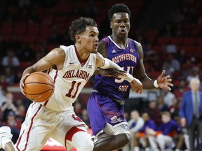 FILE - In this Dec. 19, 2017, file photo, Oklahoma guard Trae Young (11) drives past Northwestern State forward Brandon Hutton, right, in the second half of an NCAA college basketball game in Norman, Okla. The Big 12 is poised for a big week as conferences dive deep into league play. It has a national-best six teams in this week's AP Top 25 along with two games featuring a pair of ranked teams, including No. 12 Oklahoma's visit to 10th-ranked surprise TCU as the top game on the schedule for ranked teams in the week ahead.