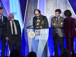FILE - In this Nov. 27, 2017, file photo, director Luca Guadagnino, center, accepts the best feature award for "Call Me By Your Name" at the 27th annual Independent Film Project's Gotham Awards at Cipriani Wall Street in New York. The Los Angeles Film Critics Association announced Sunday, Dec. 3, on Twitter that it has voted "Call Me By Your Name" the best film of the year, bestowing a total of three awards on Guadagnino's erotic coming-of-age tale.