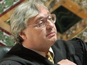 FILE - In this Sept. 22, 2003, file photo, Judge Alex Kozinski, of the 9th U.S. Circuit Court of Appeals, gestures in San Francisco. Krazinski announced his immediate retirement Monday, Dec. 18, 2017, days after women alleged he subjected them to inappropriate sexual conduct or comments. Kozinski said in a statement Monday that a battle over the accusations would not be good for the judiciary.
