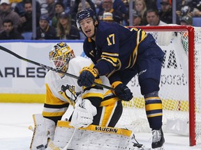 Buffalo Sabres forward Jordan Nolan (17) and Pittsburgh Penguins goalie Tristan Jerry (35) get tied up during the first period of an NHL hockey game, Friday Dec. 1, 2017, in Buffalo, N.Y.