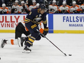 Buffalo Sabres forward Evander Kane (9) skates the puck into the zone during the first period of an NHL hockey game against the Philadelphia Flyers, Friday, Dec. 22, 2017, in Buffalo, N.Y.