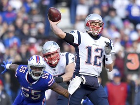 New England Patriots quarterback Tom Brady (12) throws a pass as Buffalo Bills defensive end Jerry Hughes (55) rushes by the block of offensive tackle Nate Solder (77) during the first half of an NFL football game, Sunday, Dec. 3, 2017, in Orchard Park, N.Y.