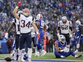 New England Patriots running back Rex Burkhead (34) gestures after scoring a touchdown against the Buffalo Bills during the second half of an NFL football game, Sunday, Dec. 3, 2017, in Orchard Park, N.Y.