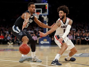Gonzaga guard Josh Perkins (13) passes the ball against Villanova guard Phil Booth (5) during the first half of an NCAA college basketball game, Tuesday, Dec. 5, 2017, in New York.