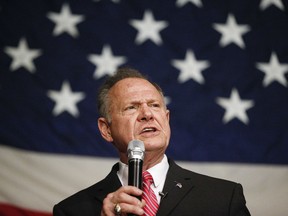 FILE- In this Dec. 5, 2017, file photo, former Alabama Chief Justice and U.S. Senate candidate Roy Moore speaks at a campaign rally in Fairhope Ala. As Alabama's high-profile Senate race heads toward a Tuesday vote, supporters and opponents Moore are bending the truth, or shattering it to pieces, in the campaign's final stretch.