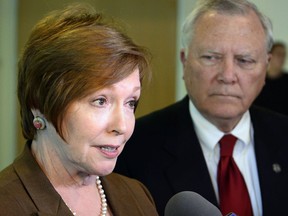 FILE - In this Oct. 16, 2014 file photo, Brenda Fitzgerald, Georgia Department of Public Health commissioner, left, and Georgia Gov. Nathan Deal respond to questions in Atlanta. Fitzgerald, the new director of the Atlanta-based Centers for Disease Control and Prevention, has kept a low profile during her five months in office, due to conflicts of interest regarding her financial holdings. In an interview with the Associated Press on Monday, Dec. 11, 2017, Fitzgerald said her conflicts of interest are settled and she's moving forward with plans for the agency.