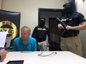 This photo provided by the Honduras public magistrate's office shows Eric Conn with Technical Agency of Criminal Investigation (ATIC) agents after he was captured by police on Monday, Dec. 4, 2017, in the city of La Ceiba, Atlantida, Honduras. Conn, a fugitive Kentucky lawyer who escaped before facing sentencing for his central role in a massive Social Security fraud case, is expected to be transferred to the U.S. on Tuesday. (Honduras public magistrate's office via AP)