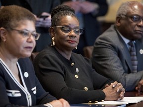 FILE- In this March 22, 2017, file photo, from left, Rep. Karen Bass, D-Calif., Rep. Gwen Moore, D-Wis., House Assistant Minority Leader James Clyburn of S.C., and other members of the Congressional Black Caucus meet with President Donald Trump in the Cabinet Room of the White House in Washington. Moore said on Tuesday, Dec. 12, that two people posing as Associated Press reporters telephoned her office, then spewed racial slurs.