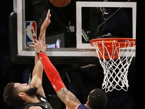 Washington Wizards forward Mike Scott, right, defends Brooklyn Nets guard Allen Crabbe, left, during the first half of an NBA basketball game, Tuesday, Dec. 12, 2017, in New York.