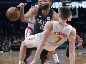 Brooklyn Nets forward Trevor Booker (35) commits an offensive foul against Atlanta Hawks forward Ersan Ilyasova (7) during the first half of an NBA basketball game, Saturday, Dec. 2, 2017, in New York.