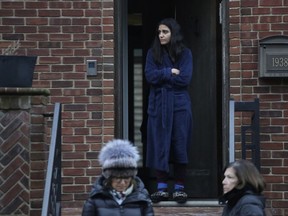 A neighbor watches the scene of a fatal fire, Monday, Dec. 18, 2017, in the Sheepshead Bay neighborhood in the Brooklyn borough of New York.