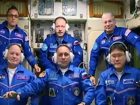 In a Tuesday, Dec. 19, 2017 photovprovided by NASA, from front left, NASA's Scott Tingle, Anton Shkaplerov of the Russian space agency Roscosmos, and Norishige Kanai of the Japan Aerospace Exploration Agency joined, from back left; Expedition 54 Commander Alexander Misurkin of Roscosmos and crewmates Mark Vande Hei and Joe Acaba of NASA aboard the International Space Station when the hatches between the Soyuz spacecraft and the orbiting laboratory officially opened Tuesday. (NASA via AP)