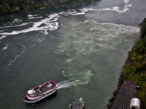 FILE- In this Oct. 9, 2017 file photo, a tour boat travels along the Niagara River in New York, where a series of overflow discharge from a treatment plant have drawn widespread attention. The sewage treatment plant that spewed a smelly black discharge at the base of Niagara Falls during the busy summer tourist season is in line for $20 million in upgrades. Gov. Andrew Cuomo proposed the state investment Tuesday, Dec. 19 as one of his 2018 priorities.