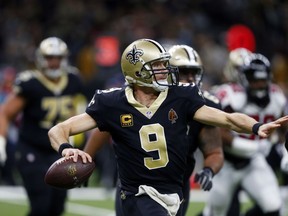 FILE - This Dec. 24, 2017 file photo shows New Orleans Saints quarterback Drew Brees (9) passing in the second half of an NFL football game against the Atlanta Falcons in New Orleans. Brees is on the verge of reclaiming an NFL record this week, just weeks before his 39th birthday. Brees enters New Orleans' season finale at Tampa Bay with a completion percentage of 71.9. If that holds, he'll break the single-season record of 71.7 percent set by Minnesota's Sam Bradford last season. Brees says improvements to the running game and defense have produced less risky game plans featuring higher-percentage throws.