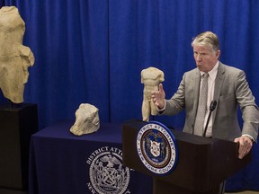 FILE - In this Dec. 15, 2017 file photo, Manhattan District Attorney Cyrus R. Vance discusses the repatriation of three ancient sculptures during a news conference in New York. The sculptures, from left, the "Calf Bearer', the 'Bull's Head', and the 'Torso', are being returned to their rightful owners in Lebanon as Vance forms a new antiquities trafficking unit. They were stolen from a temple during the Lebanese civil war that started in 1975.