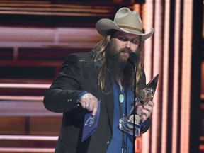 FILE - In a Wednesday, Nov. 8, 2017 file photo, Chris Stapleton accepts the award for album of the year "From A Room: Volume 1" at the 51st annual CMA Awards at the Bridgestone Arena, in Nashville, Tenn.