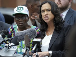 FILE - In a Wednesday, July 27, 2016 file photo, Baltimore State's Attorney Marilyn Mosby, right, holds a news conference near the site where Freddie Gray was arrested after her office dropped the remaining charges against three Baltimore police officers awaiting trial in Gray's death, in Baltimore.  The 4th U.S. Circuit Court of Appeals will hear arguments Wednesday, Dec. 6, 2017, in Mosby's bid to overturn a decision from a judge who ruled that parts of the lawsuit filed against Mosby by five Baltimore police officers charged in the death of Freddie Gray can move forward.
