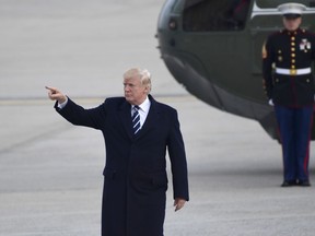 President Donald Trump gestures as he walks towards Air Force One at John F. Kennedy International Airport in New York, Saturday, Dec. 2, 2017. Trump spent the day in New York attending a trio of fundraisers.