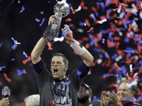 2017 AP YEAR END PHOTOS - New England Patriots' Tom Brady raises the Vince Lombardi Trophy after defeating the Atlanta Falcons in overtime at the NFL Super Bowl 51 football game on Feb. 5, 2017, in Houston. The Patriots defeated the Falcons 34-28. (AP Photo/Darron Cummings)