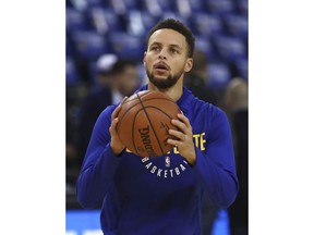 Golden State Warriors' Stephen Curry warms up prior to an NBA basketball game against the Charlotte Hornets on Friday, Dec. 29, 2017, in Oakland, Calif.