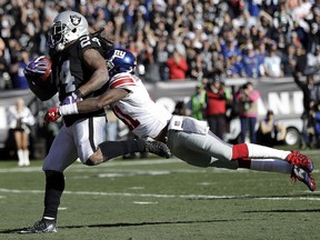 Oakland Raiders running back Marshawn Lynch (24) scores a touchdown in front of New York Giants cornerback Dominique Rodgers-Cromartie during the first half of an NFL football game in Oakland, Calif., Sunday, Dec. 3, 2017.