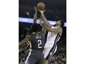 Golden State Warriors forward Draymond Green, back left, blocks a shot by Denver Nuggets forward Wilson Chandler, right, during the first half of an NBA basketball game in Oakland, Calif., Saturday, Dec. 23, 2017.