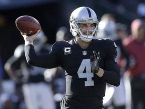 Oakland Raiders quarterback Derek Carr (4) passes against the New York Giants during the first half of an NFL football game in Oakland, Calif., Sunday, Dec. 3, 2017.