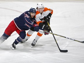 Columbus Blue Jackets center Boone Jenner (38) battles for the puck against Philadelphia Flyers center Nolan Patrick (19) during the second period of an NHL hockey game in Columbus, Ohio, Saturday, Dec. 23, 2017.
