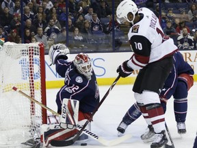 Columbus Blue Jackets' Sergei Bobrovsky, left, of Russia, makes a save against Arizona Coyotes' Anthony Duclair during the first period of an NHL hockey game Saturday, Dec. 9, 2017, in Columbus, Ohio.
