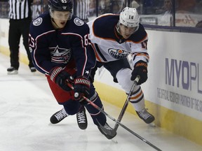 Columbus Blue Jackets' Markus Nutivaara, left, of Finland, carries the puck away from Edmonton Oilers' Ryan Strome during the first period of an NHL hockey game Tuesday, Dec. 12, 2017, in Columbus, Ohio.