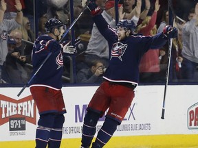Columbus Blue Jackets' Josh Anderson, right, celebrates his goal against the Anaheim Ducks with teammate Jack Johnson during the third period of an NHL hockey game Friday, Dec. 1, 2017, in Columbus, Ohio.