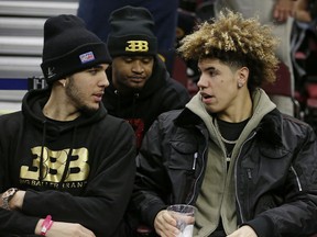 LiAngelo Ball, left, and his brother, LaMelo, talk before an NBA basketball game between the Los Angeles Lakers and the Cleveland Cavaliers, Thursday, Dec. 14, 2017, in Cleveland.