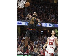 Cleveland Cavaliers' LeBron James (23) drives to the basket past Chicago Bulls' Lauri Markkanen (24), from Finland, durign the first half of an NBA basketball game Thursday, Dec. 21, 2017, in Cleveland.