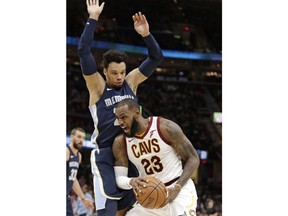 Cleveland Cavaliers' LeBron James (23) drives against Memphis Grizzlies' Dillon Brooks (24) in the first half of an NBA basketball game, Saturday, Dec. 2, 2017, in Cleveland.