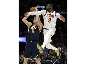 Utah Jazz's Jonas Jerebko (8), from Sweden, shoots against Cleveland Cavaliers' Dwyane Wade (9) in the first half of an NBA basketball game, Saturday, Dec. 16, 2017, in Cleveland.