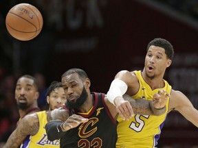 Cleveland Cavaliers' LeBron James, front left, and Los Angeles Lakers' Josh Hart, right, battle for the ball in the second half of an NBA basketball game, Thursday, Dec. 14, 2017, in Cleveland.