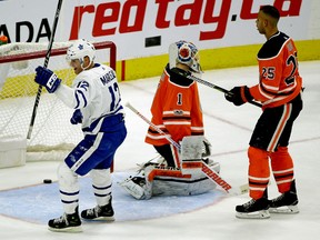 Patrick Marleau of the Maple Leafs skates past Oilers goalie Laurent Brossoit and defenceman Darnell Nurse after a Toronto goal late in the third period on Thursday night in Edmonton.