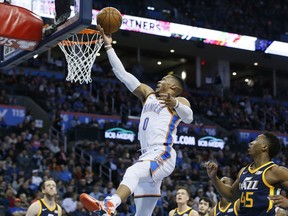 Oklahoma City Thunder guard Russell Westbrook (0) shoots in front of Utah Jazz guard Donovan Mitchell (45) in the first quarter of an NBA basketball game in Oklahoma City, Tuesday, Dec. 5, 2017.