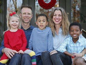 In this Sunday, Dec. 3, 2017, photo, Lance and Stephanie Schmidt pose for a photo with their children, from left, Stella, Theo and Solomon, at their home in Oklahoma City. The Schmidts have opted for a cost-sharing ministry this year after they realized their monthly insurance bill would have more than doubled to over $1,200 and stuck them with an $8,000 deductible for their family of five.