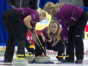 Skip Jennifer Jones looks on as skip Chelsea Carey, third Cathy Overton-Clapham (right) and lead Laine Peters (left) watch a shot enter the house during the Olympic curling trials Wednesday in Ottawa.