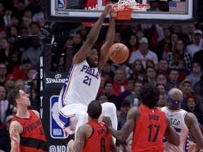 Philadelphia 76ers center Joel Embiid, center, dunks against the Portland Trail Blazers during the first half of an NBA basketball game in Portland, Ore., Thursday, Dec. 28, 2017.