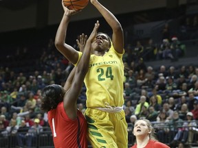 Oregon's Ruthy Hebard, center, shoots between Mississippi's Bree Glover and Shelby Gibson during the first half of an NCAA college basketball game in Eugene, Ore., Sunday Dec. 17, 2017.
