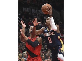 New Orleans Pelicans guard Rajon Rondo drives to the basket next to Portland Trail Blazers guard Damian Lillard during the first half of an NBA basketball game in Portland, Ore., Saturday, Dec. 2, 2017.
