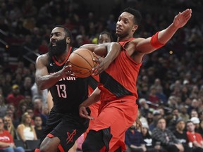 Houston Rockets guard James Harden drives to the basket on Portland Trail Blazers guard Evan Turner during the first half of an NBA basketball game in Portland, Ore., Saturday, Dec. 9, 2017.