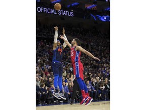 Oklahoma City Thunder's Carmelo Anthony, left, shoots the ball with Philadelphia 76ers' Ben Simmons, right, of Australia, defending during the first half of an NBA basketball game, Friday, Dec. 15, 2017, in Philadelphia.
