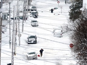 Erie, Pa., residents on East 24th Street dig out on Tuesday, Dec. 26, 2017, after a record two-day snowfall. The National Weather Service office in Cleveland says the storm brought 34 inches on Christmas Day, a new all-time daily snowfall record for Erie.