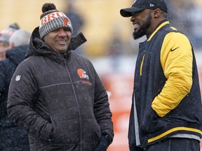 Cleveland Browns head coach Hue Jackson, left, and Pittsburgh Steelers head coach Mike Tomlin visit on the field during warmups before an NFL football game in Pittsburgh, Sunday, Dec. 31, 2017.